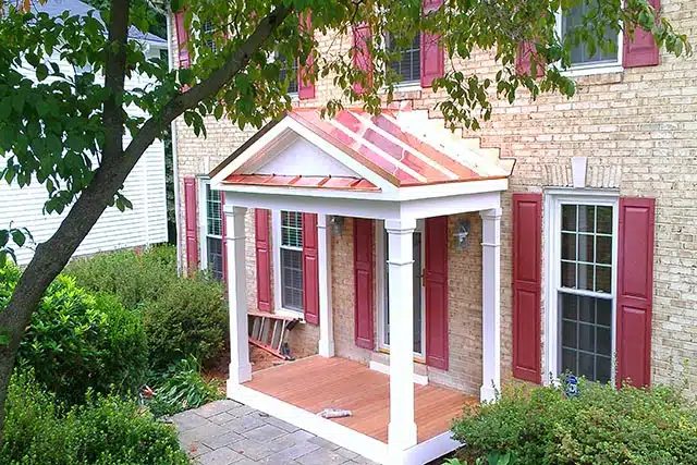 Brick home with new portico and copper roof