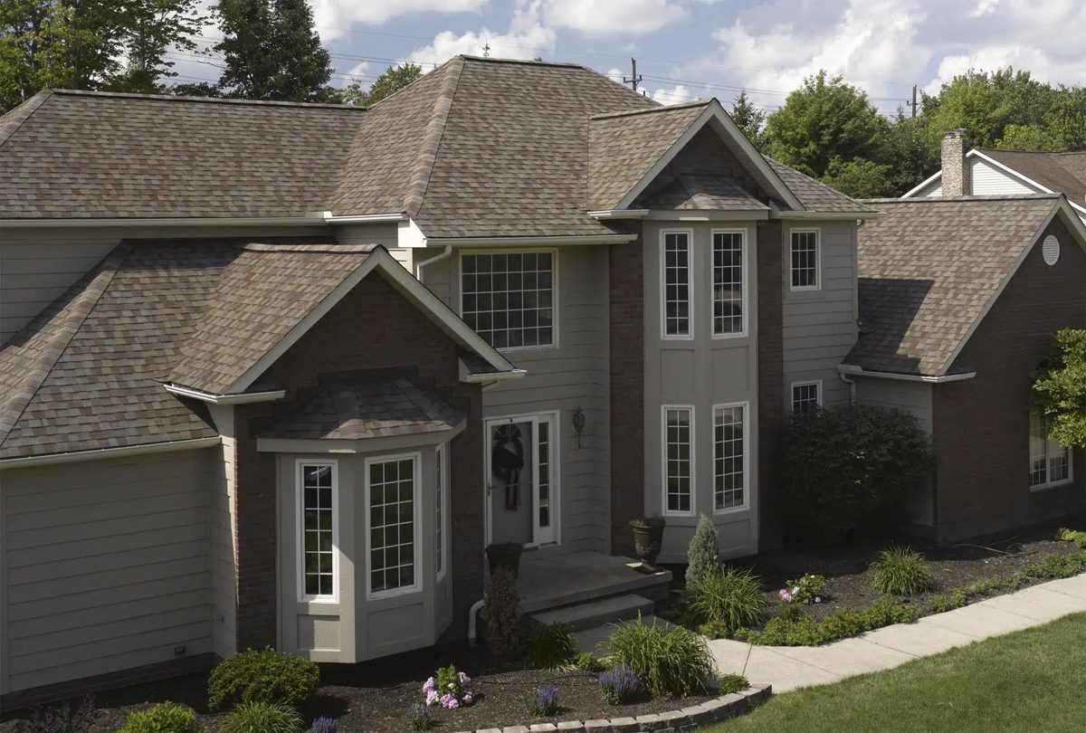 Gray two-story home with new architectural shingle roof